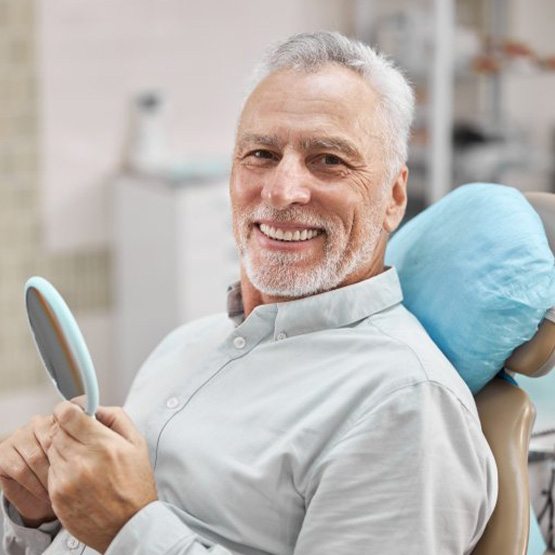 a patient smiling while visiting his dentist