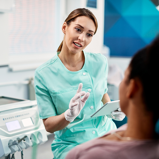 Dental team member asking a patient questions