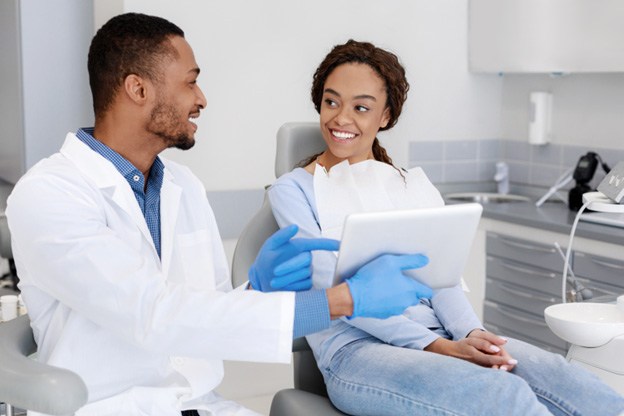 Dentist and Patient in chair smiling