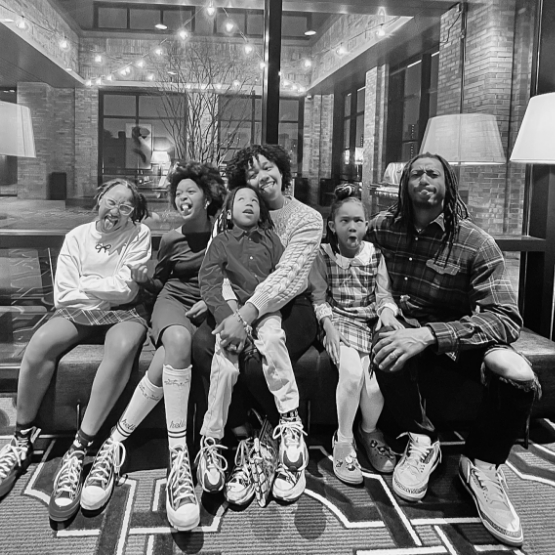 Doctor Q and his family sitting on a couch and making silly faces