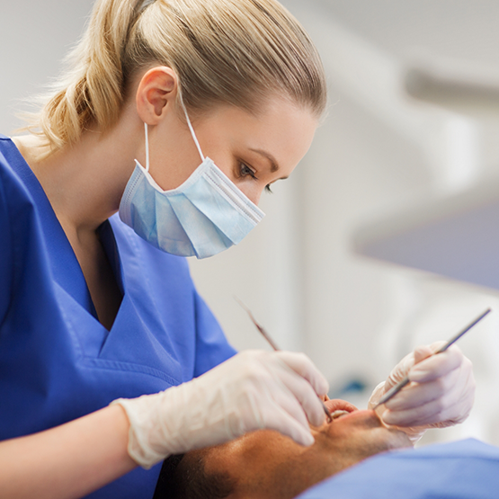 Dentist examining a patients mouth
