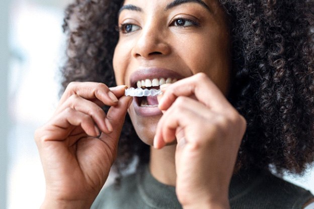 Woman pulling back upper lip to reveal darkened gums