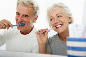 Older adults brushing their teeth